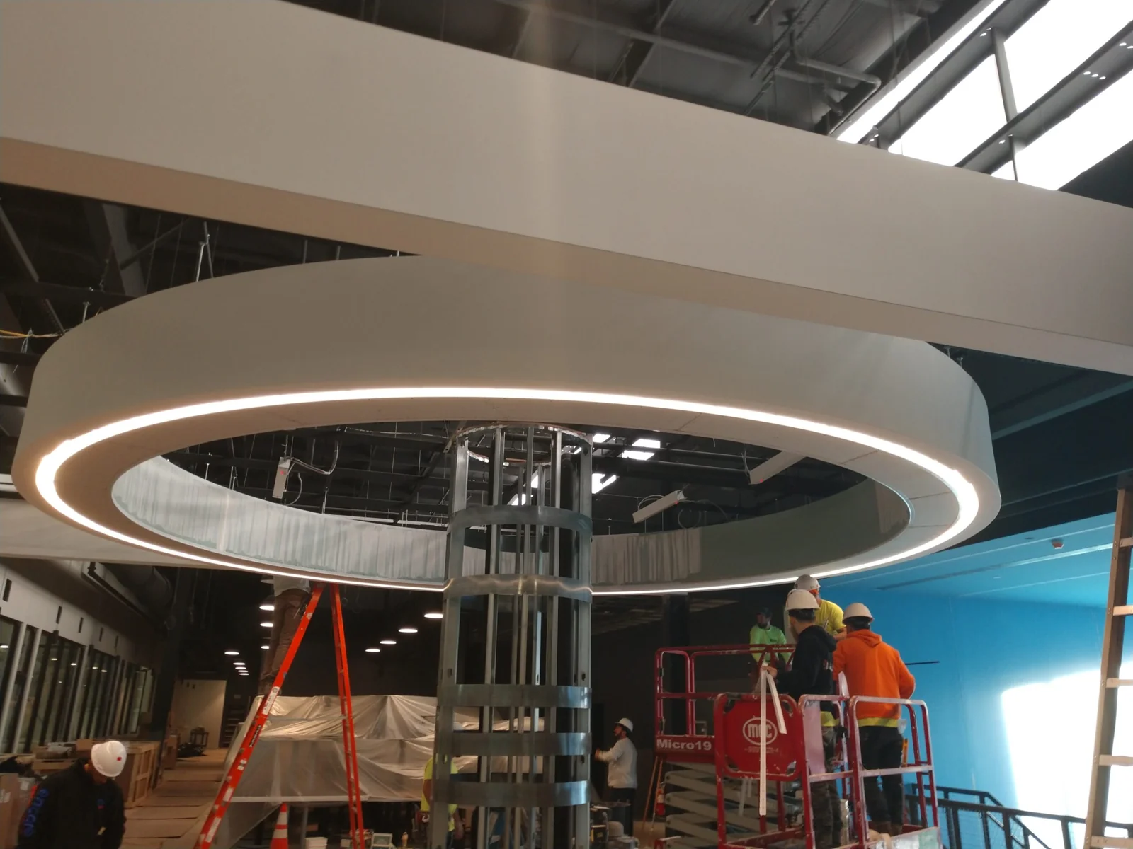 Circular drywall soffit and exposed column framing during interior construction